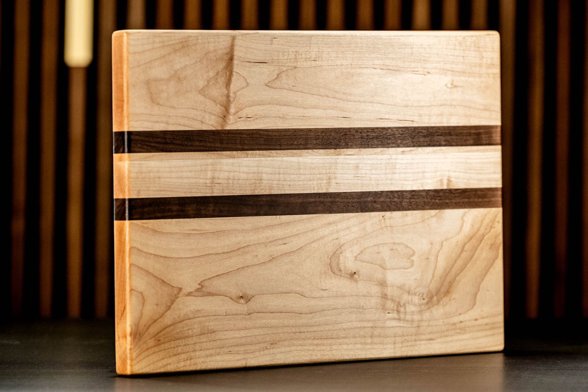 Wooden cutting board with dark wood inlays for kitchen use. 03 06 26 lagniappe 031