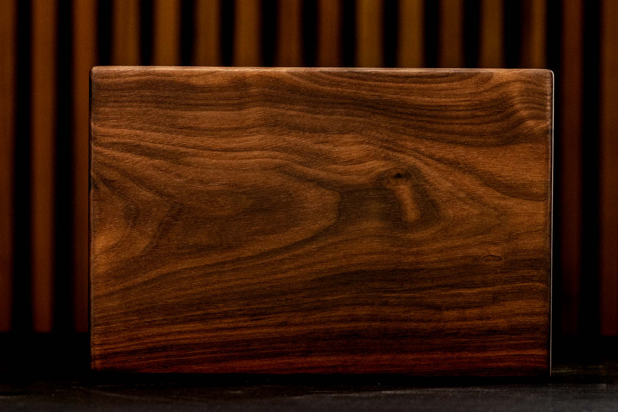 Wooden cutting board by Lagniappe Woodworks, showcasing handcrafted craftsmanship and rich wood grain.